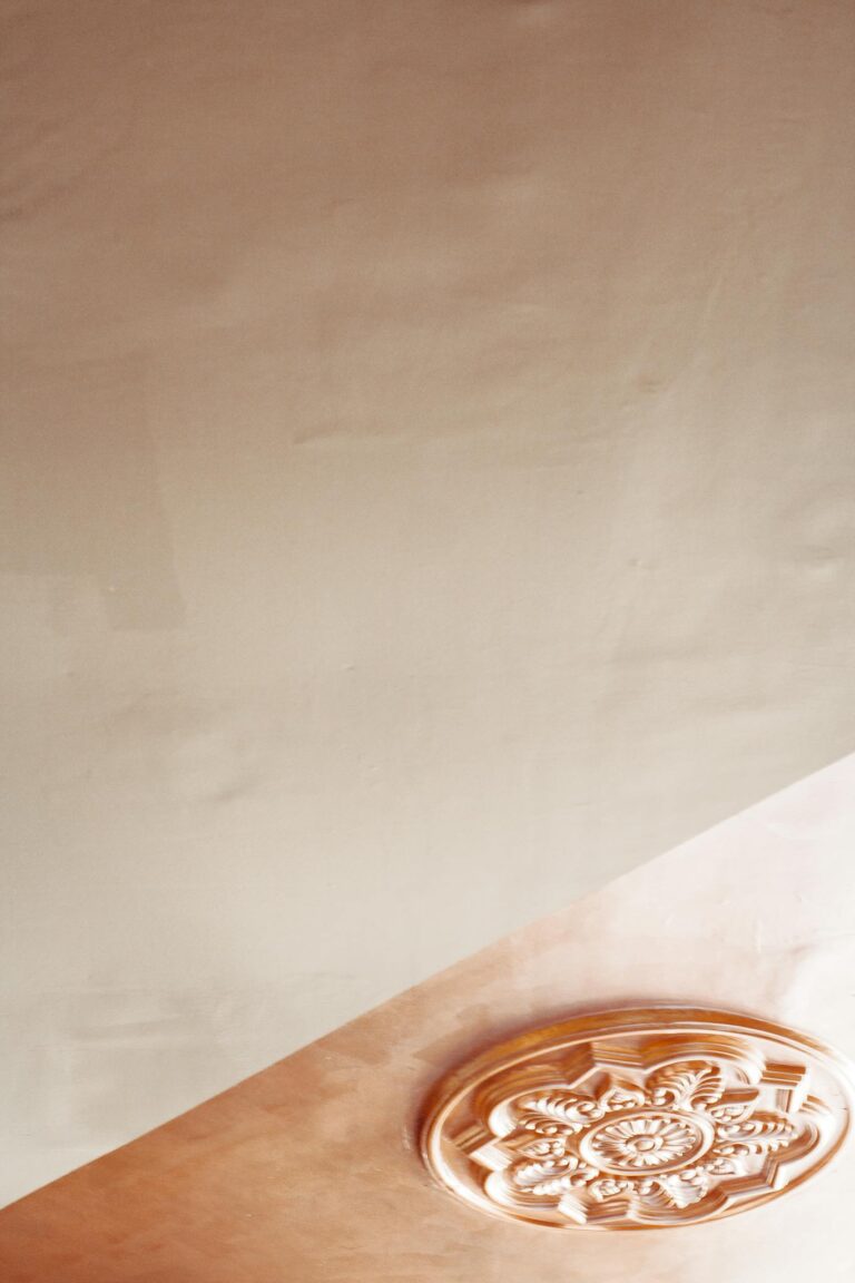 Close-up of a beautifully carved antique ceiling ornament, an artistic display of intricate design.